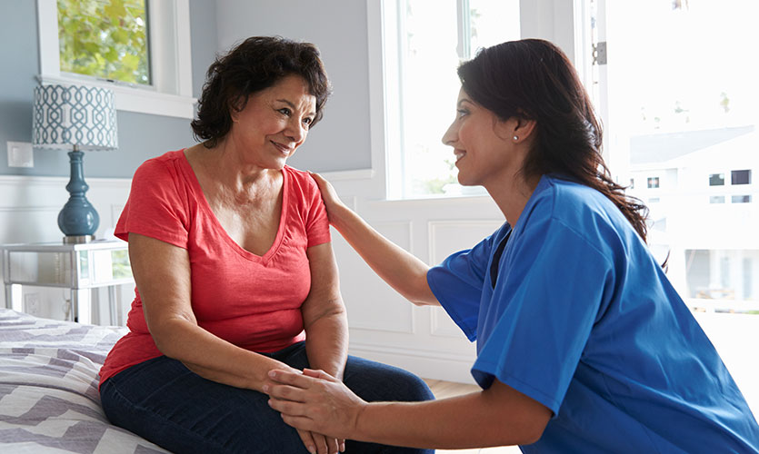 In-home nurse caring for an elderly woman