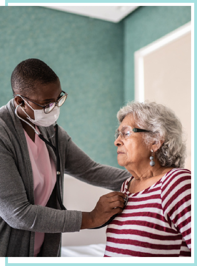 Female hospice nurse checking on a female patient