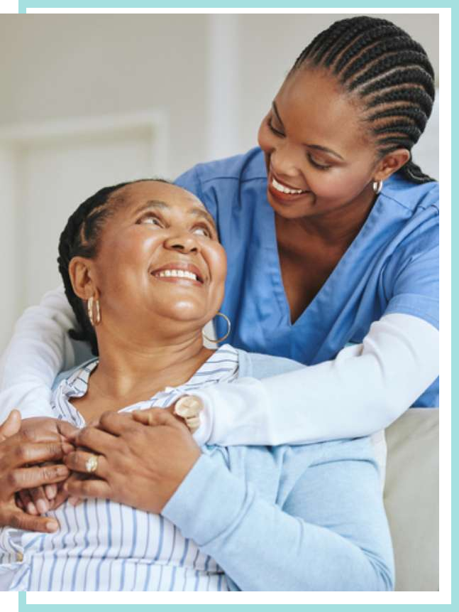 Female nurse embracing female patient