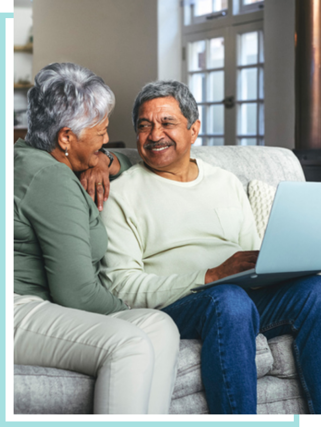 Elderly patients at home happy using a laptop.