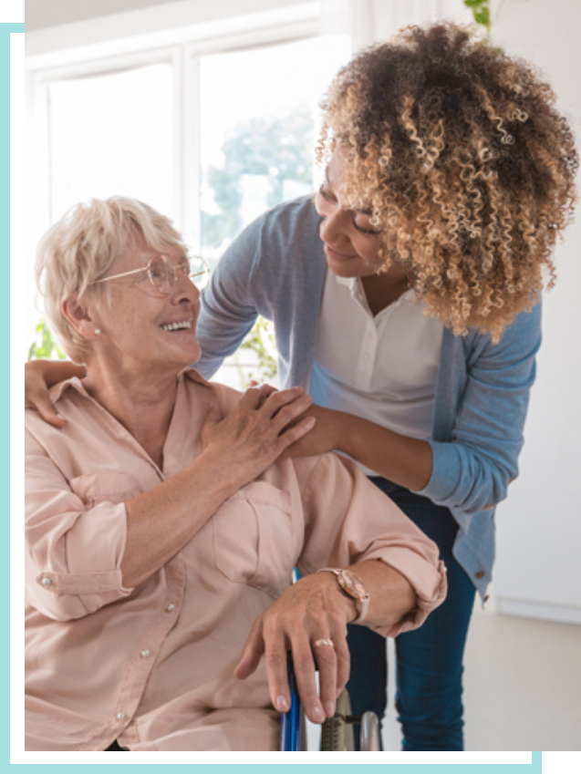 Two women looking at each other, one in a wheelchair