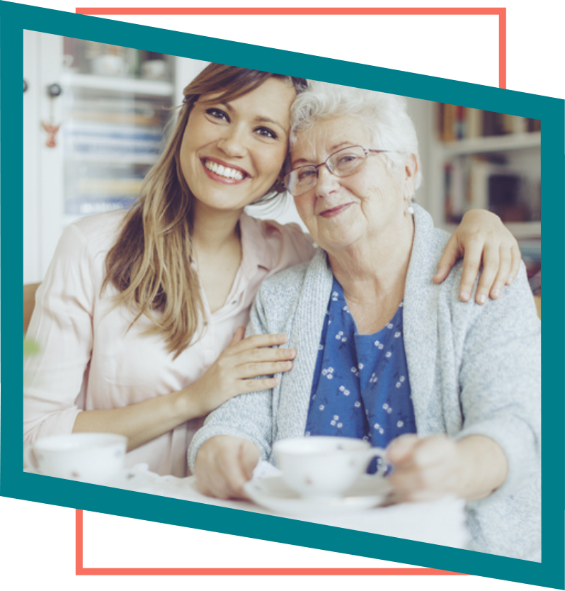 Family member posing with patient grandmother for a picture.