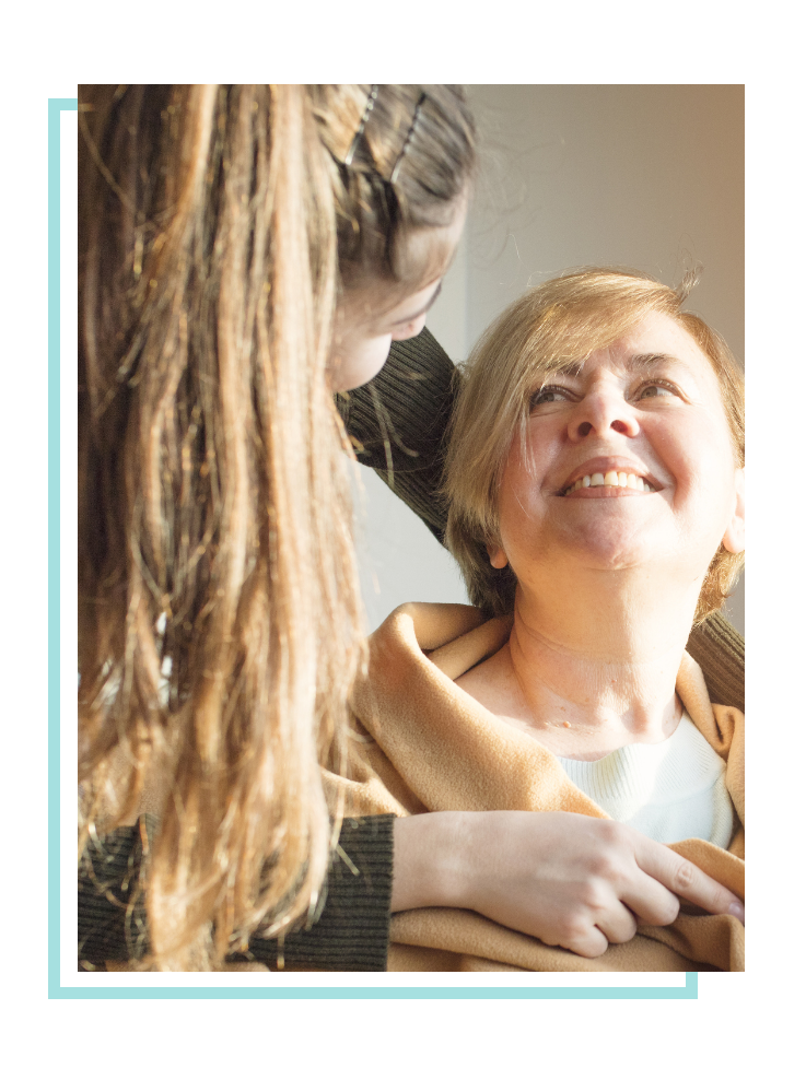 Mom and daughter looking and smiling at each other