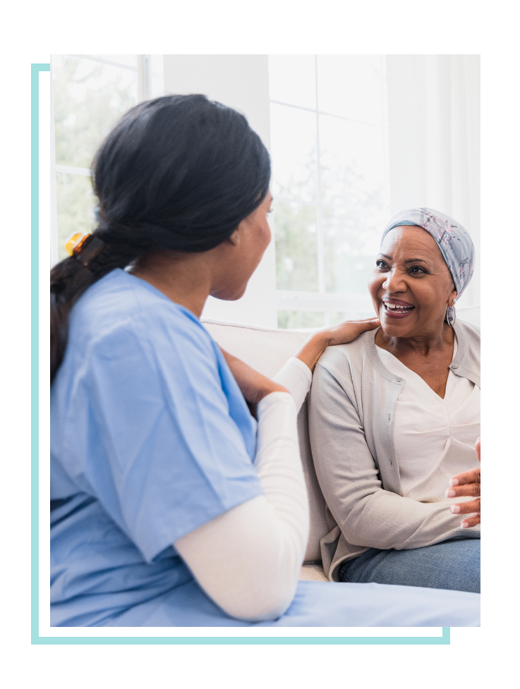 Female nurses speaking with palliative care patient