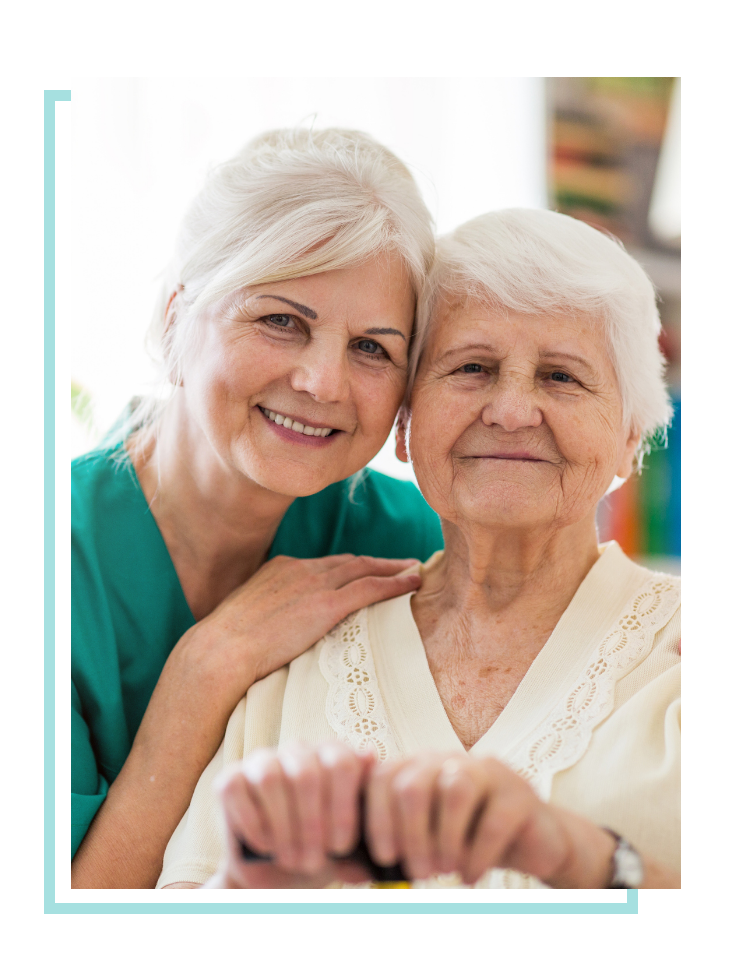 Family member posing with patient grandmother for a picture.