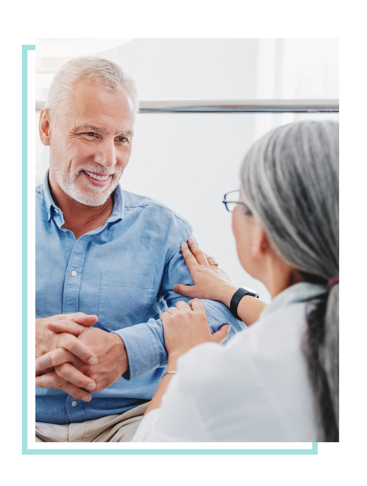 Female physician comforting male patient