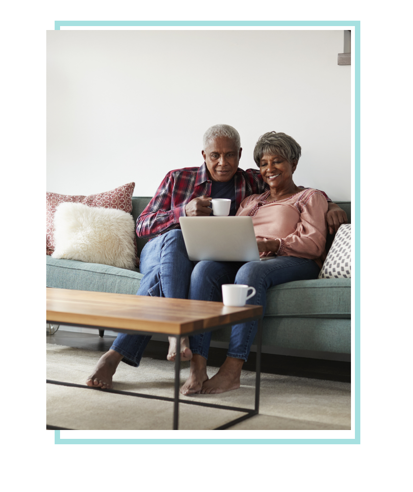 Elderly couple exploring care options on laptop