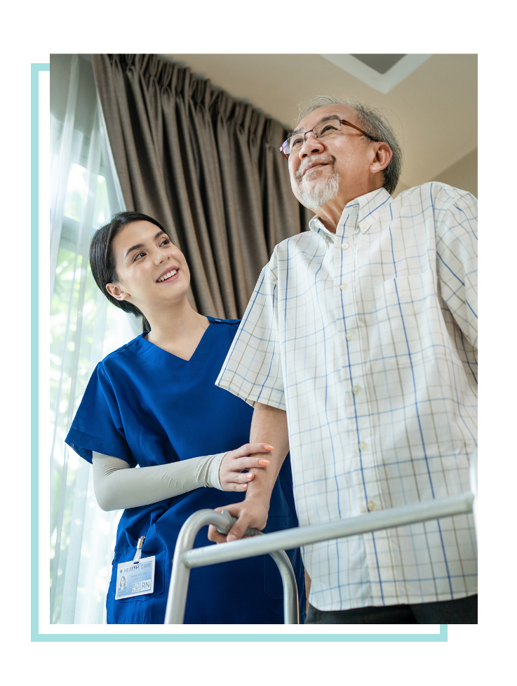 Female nurse assisting elderly man with walker.