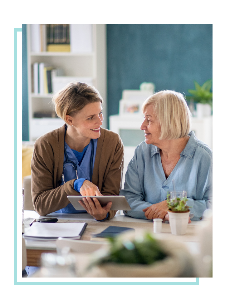 Female doctor explaining care to an elderly female patient.