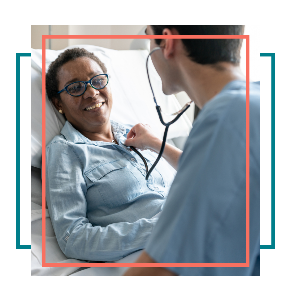 Male palliative care nurse checking on a female patient