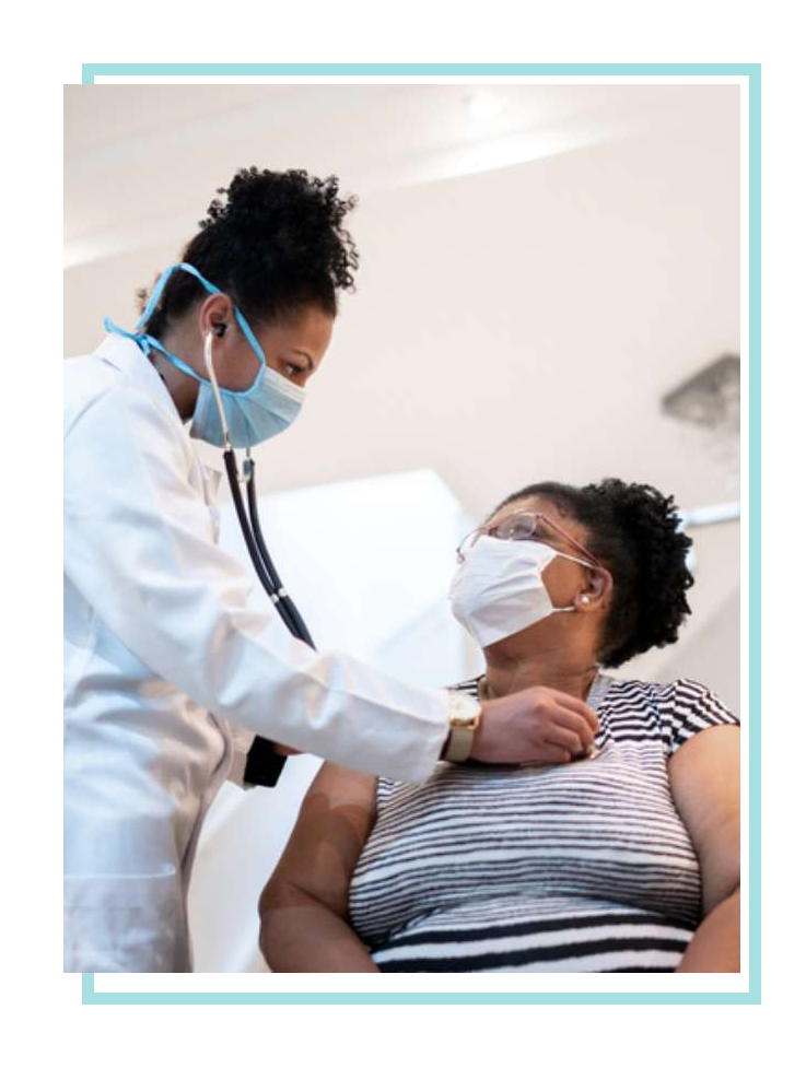 Female doctor using stethoscope with female patient.