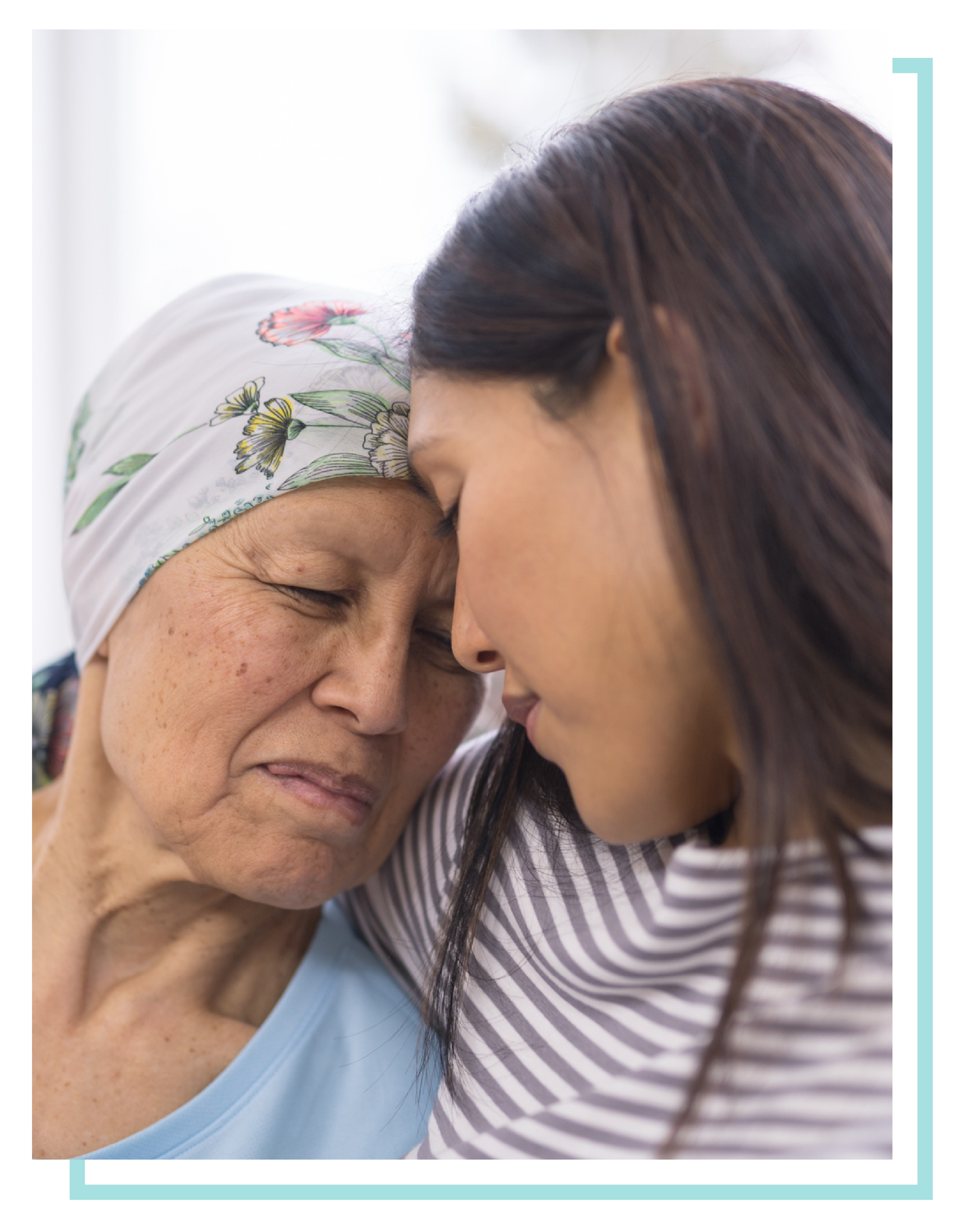 Elderly hospice woman touching foreheads with her daughter