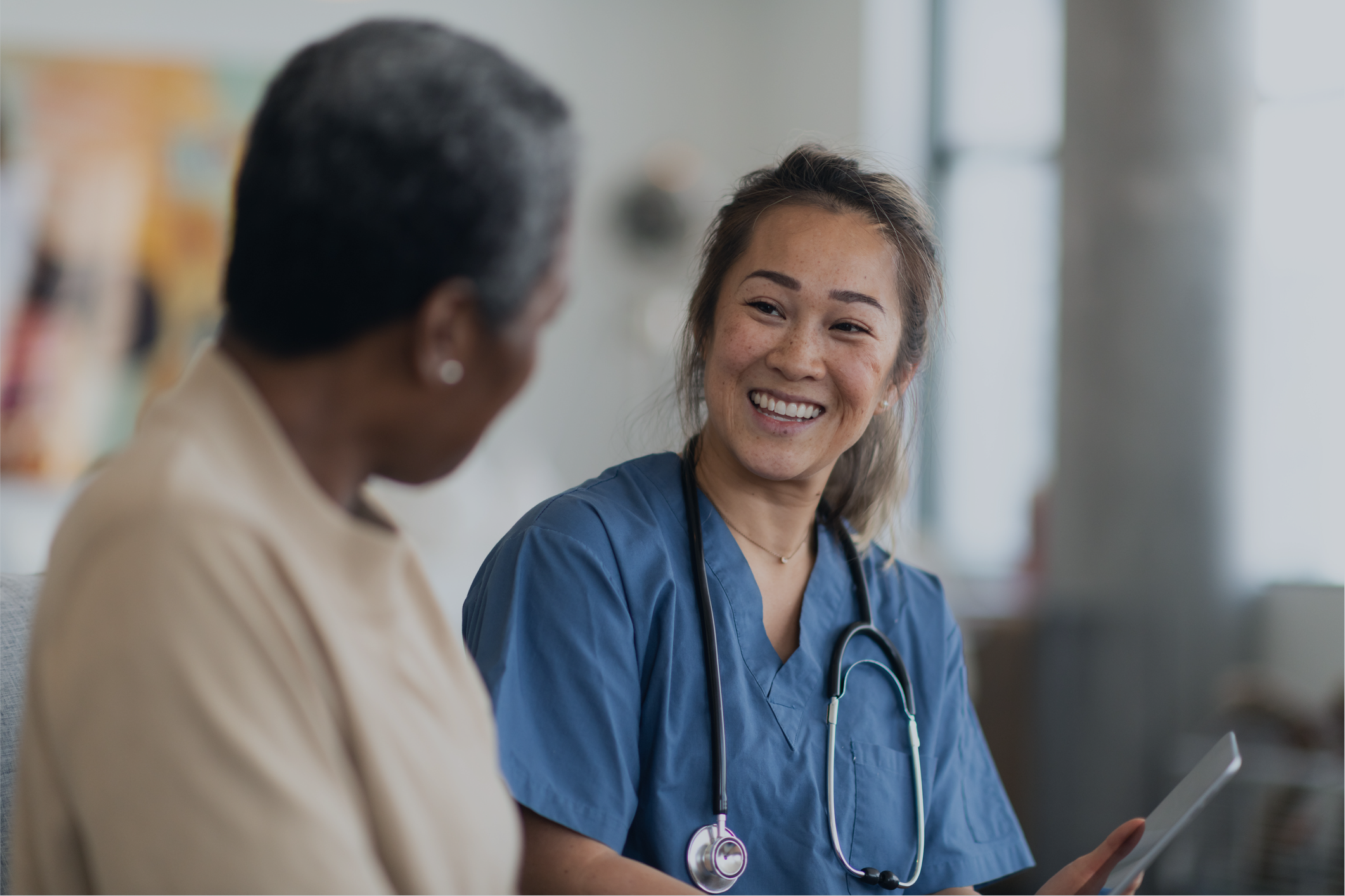 Female physician laughing with her male patient