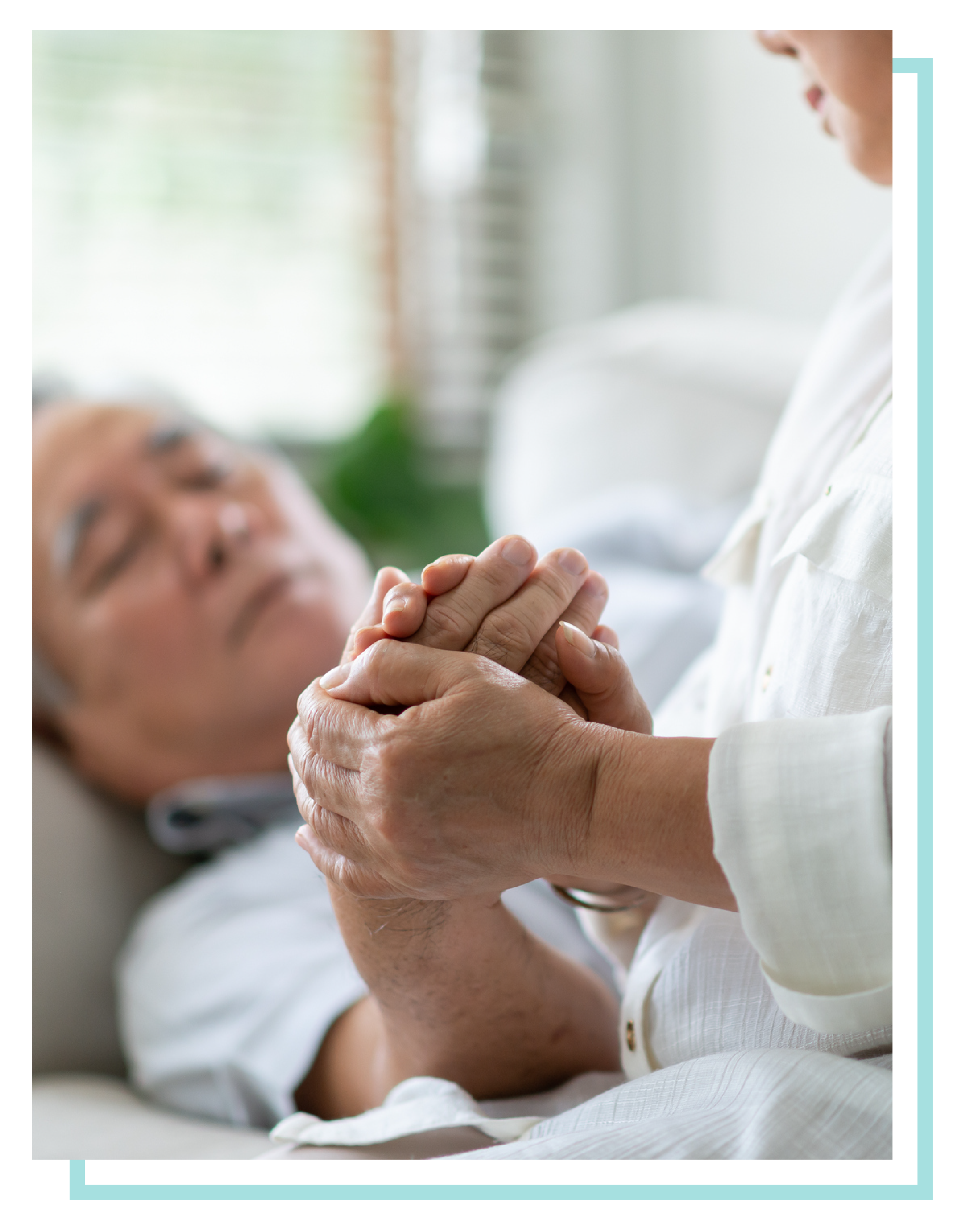 Female physician holding an elderly man's hand