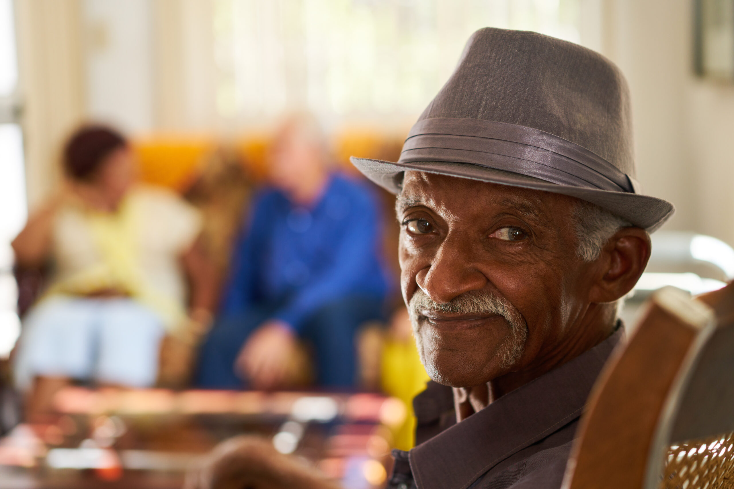 Man wearing a hat looking past the camera