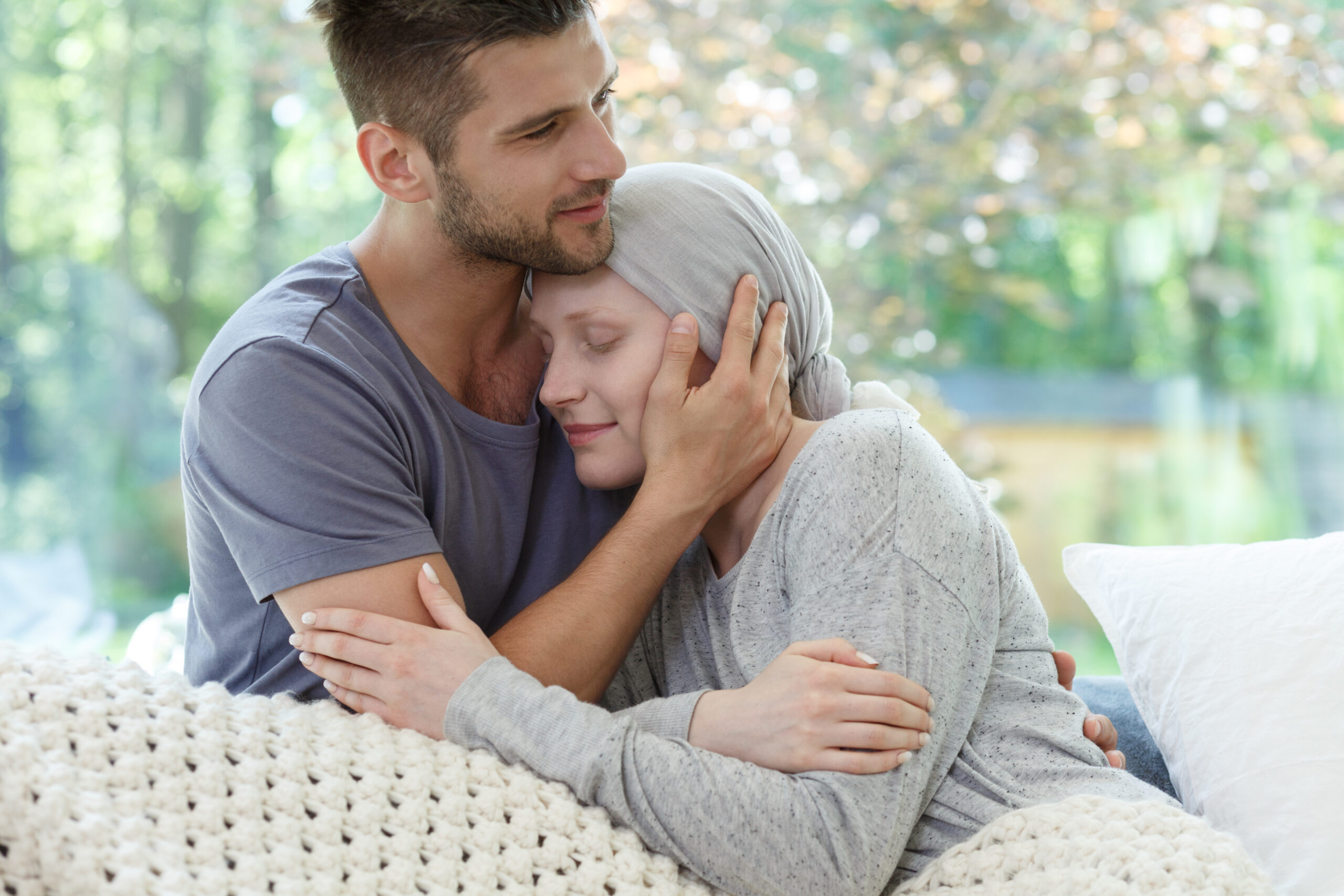 Husband comforting his wife who has cancer.