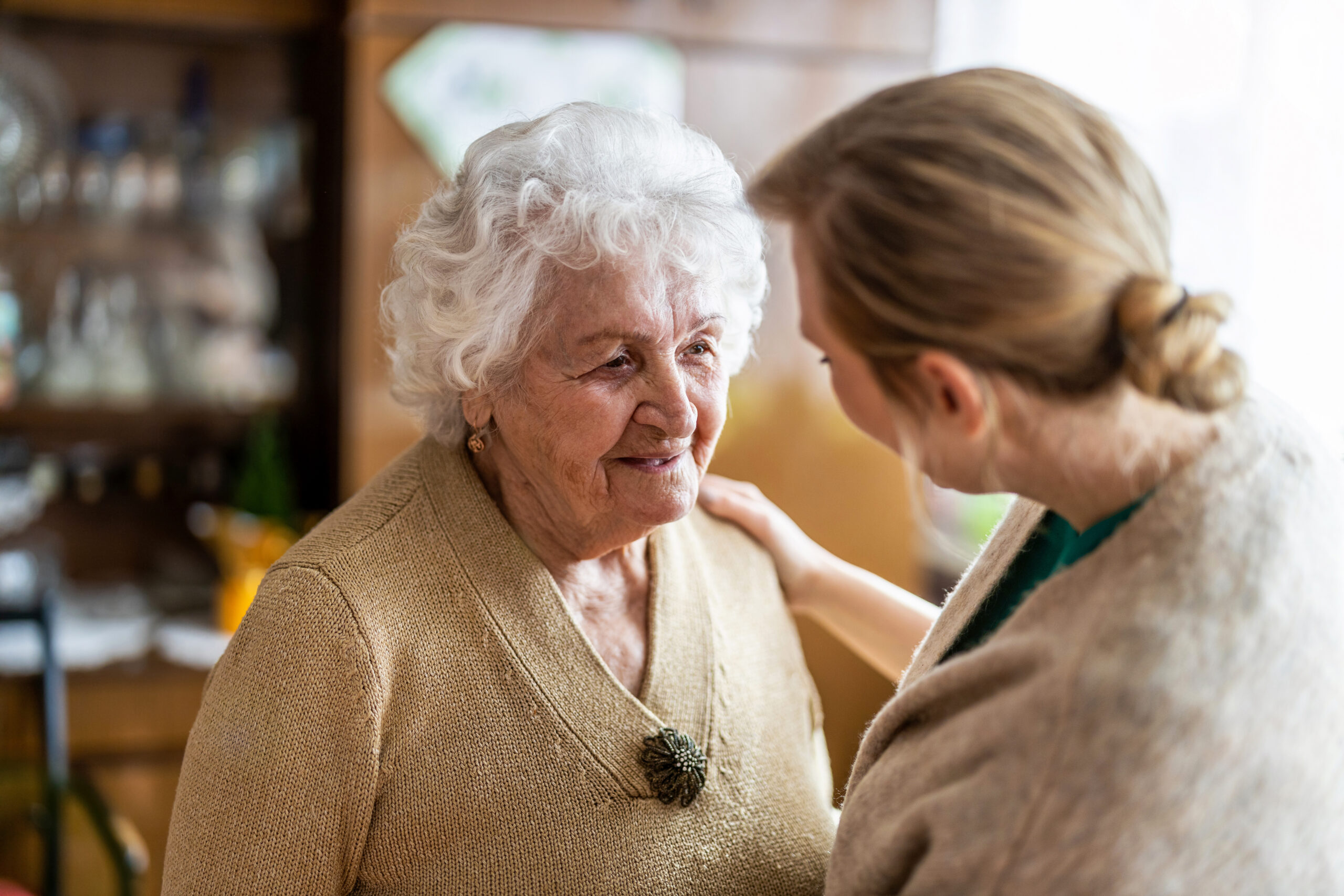 Young nurse comforting a patient with Advanced Alzheimer's Disease