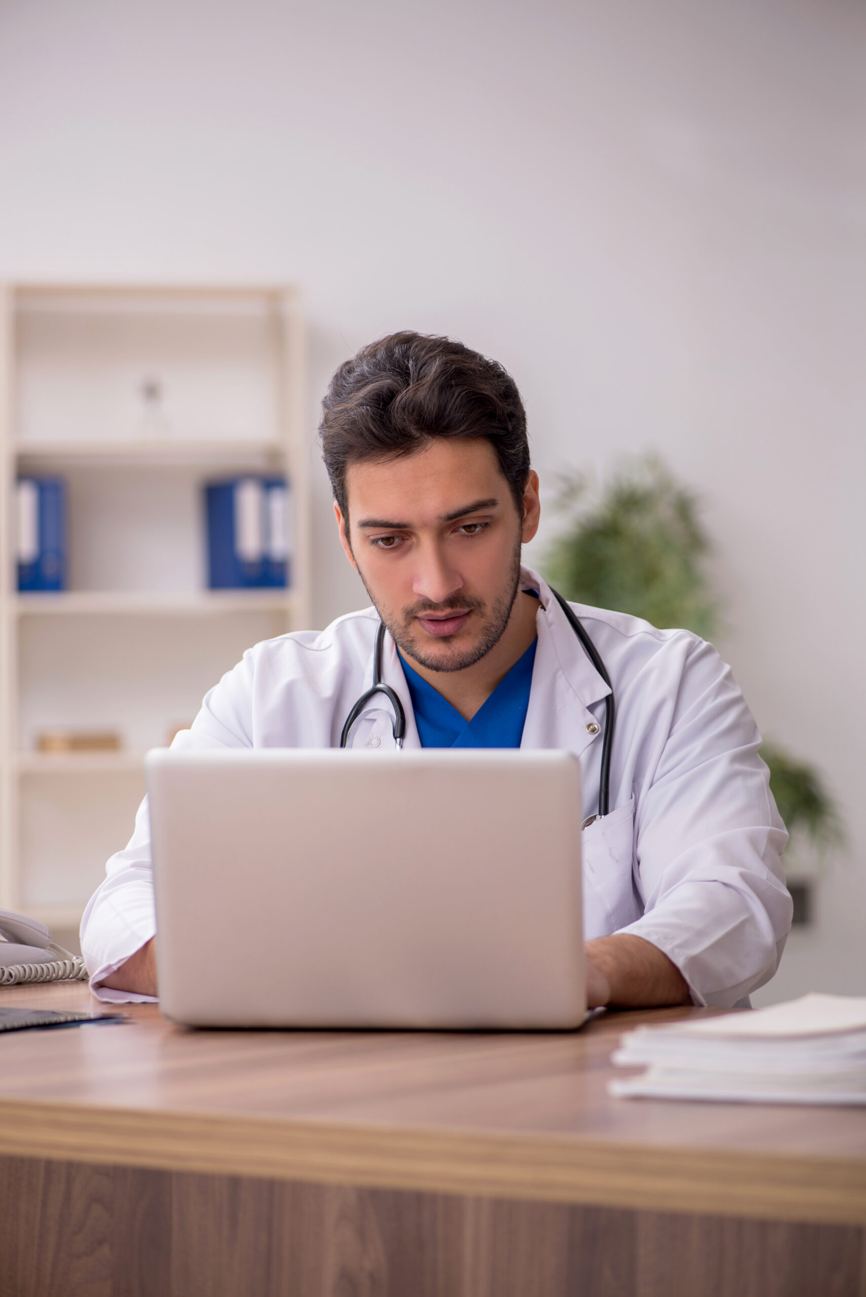 Young health care provider submitting an order for a patient online.