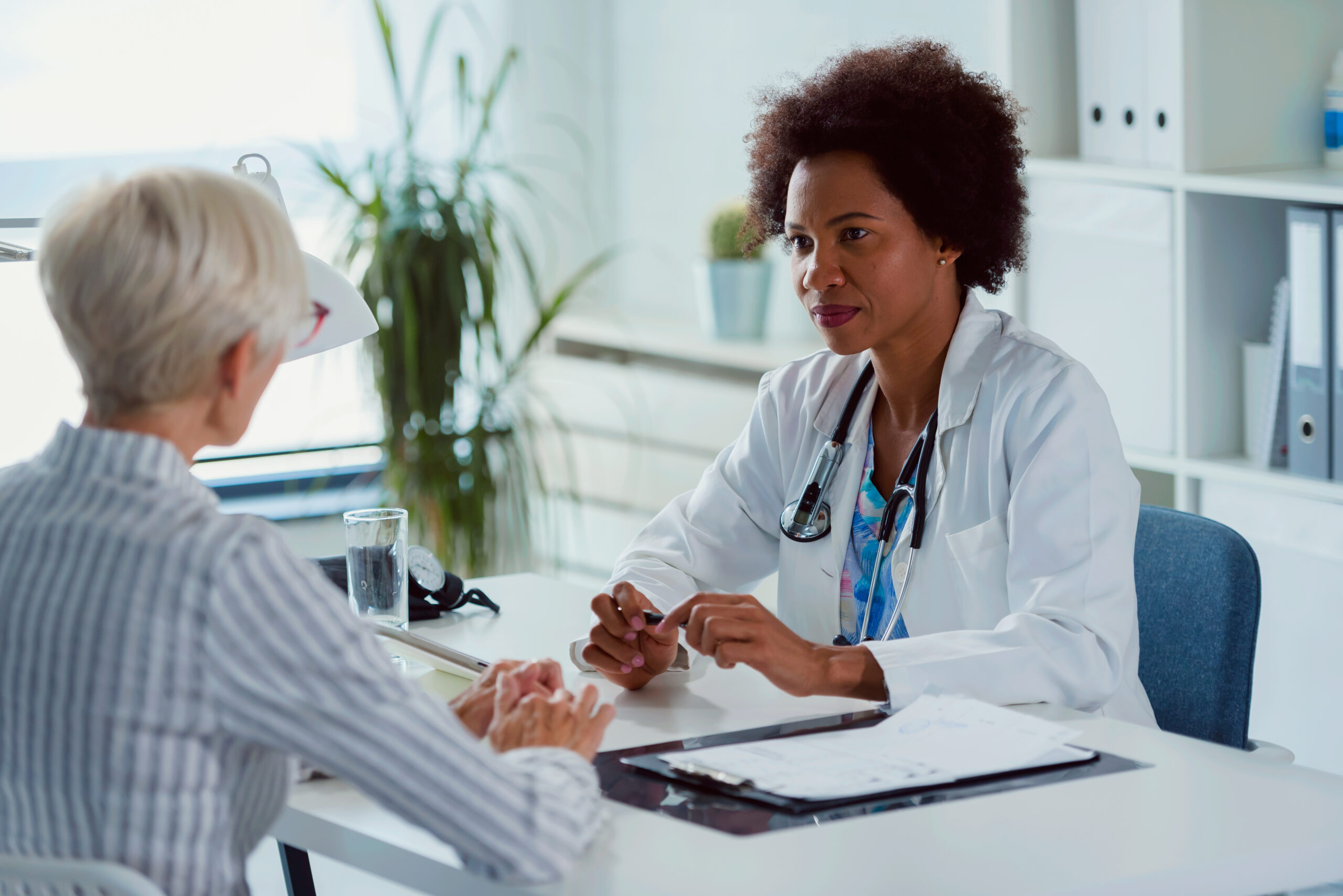 Female doctor discussing treatment with a patient