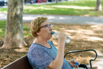 Woman drinking water during extreme heat